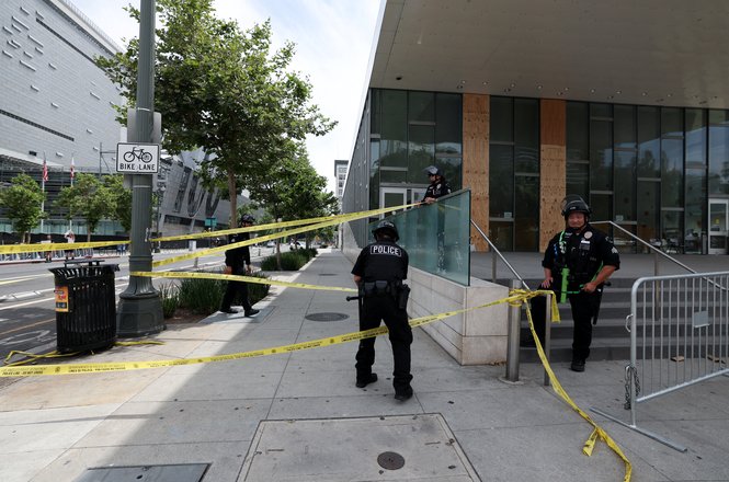 Officers set up tape outside the Los Angeles Police Department during a “No Kings” protest in California on June 14, 2025.