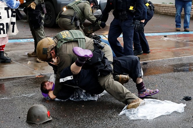 A federal officer grapples with a protester at a U.S. Immigration and Customs Enforcement demonstration in Portland, Oregon, on Oct. 12, 2025.