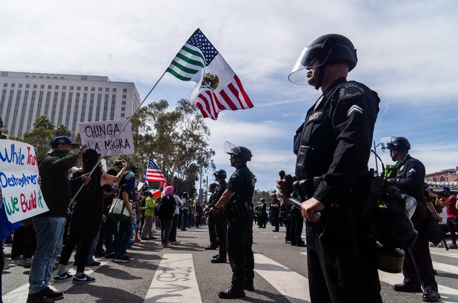 Protesters stand off with police in downtown Los Angeles on June 14, 2025. Freelance photojournalist Madison Swart was struck with multiple crowd-control munitions while covering the protests against the Trump administration and its immigration policy.