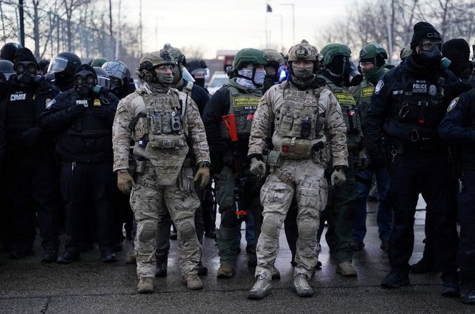 Federal officers and other law enforcement stand guard at the Whipple Federal Building amid immigration protests in the Minneapolis, Minnesota, area on Jan. 17, 2026.