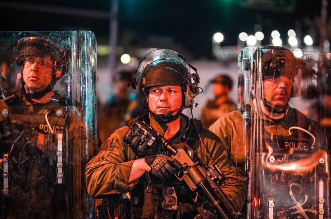Police officers with riot shields and crowd-control weapons outside a detention facility in Newark, New Jersey, on May 31, 2026.