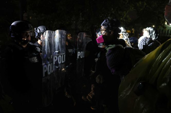 Police officers and demonstrators face off outside a federal detention center in Newark, New Jersey, on June 6, 2026. Independent journalist Wali Khan was struck with a shield by an officer while covering the protests that night.