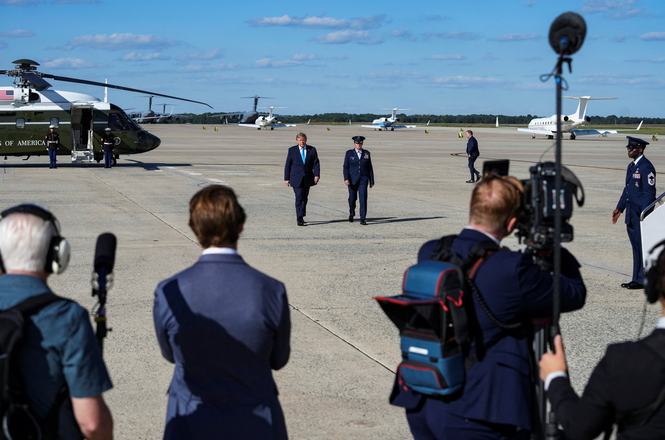 President Donald Trump, at center left, walks to board Air Force One for a flight to Nebraska on Oct. 5, 2026. The day before, the White House barred Politico from joining the president’s travel press pool for the trip.