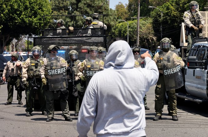 Los Angeles County sheriff’s deputies advance during an immigration protest in Paramount, California, on June 7, 2025. An agency staff photographer was injured by stun grenade shrapnel after deputies pushed the demonstration across the bridge to Compton.