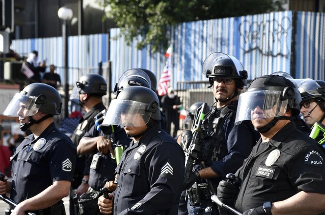 Police officers stand guard during an anti-deportation protest in Los Angeles, California, on June 9, 2025.