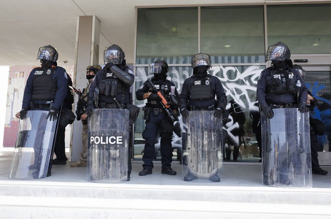 Immigration and Customs Enforcement officers guard the Los Angeles Federal building during a protest against immigration enforcement raids on June 9, 2025. Photojournalist Ted Soqui was shot with rubber bullets that day while documenting the protest.