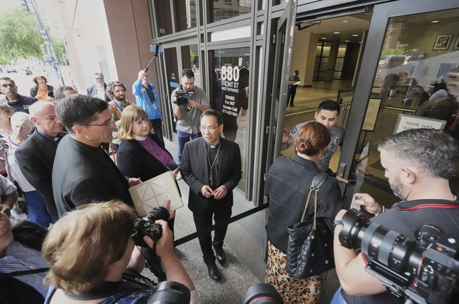 An interfaith group entering a federal building during immigration hearings on June 20, 2025, in San Diego, California. Photojournalist Jonathan Chang was prevented from bringing his camera into the same building on Dec. 5.