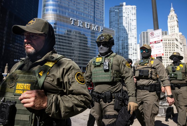 Federal agents from U.S. Immigration and Customs Enforcement and U.S. Customs and Border Protection walk along West Wacker Drive in Chicago on Sept. 28, 2025.
