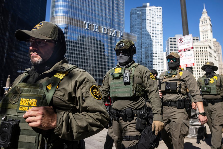 Federal agents from U.S. Immigration and Customs Enforcement and U.S. Customs and Border Protection walk in Chicago.