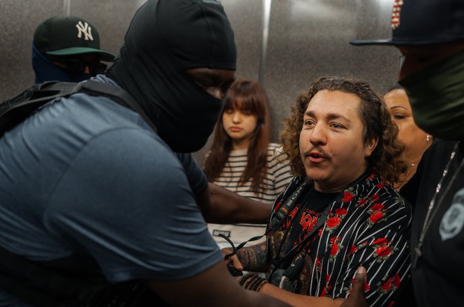 Federal agents push and pull amNewYork police bureau chief and photojournalist Dean Moses from a public elevator outside the immigration court in New York City on Sept. 30, 2025.