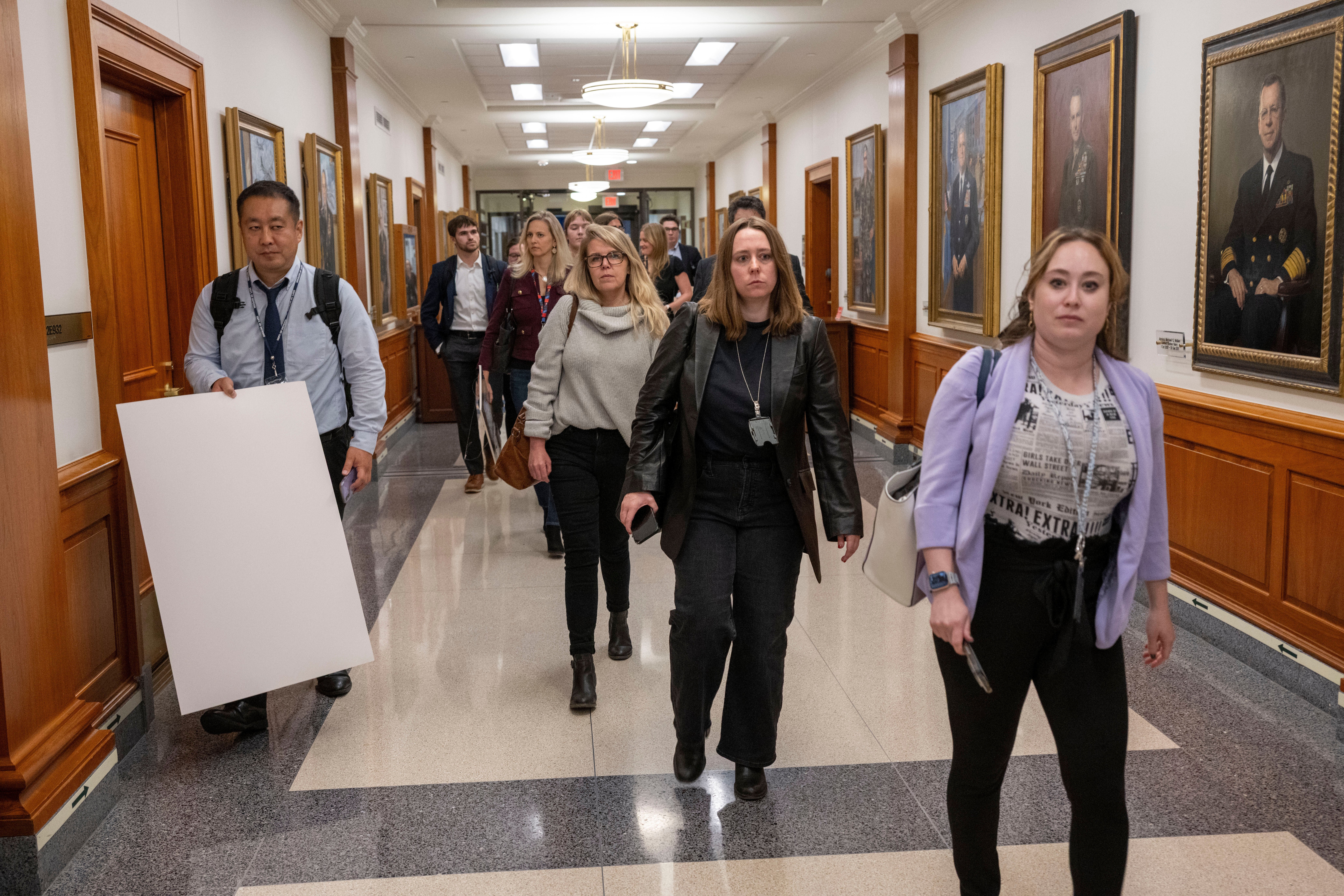 Pentagon press corps members walk out of the building en masse on Oct. 15, 2025, after losing their press credentials for refusing to sign new guidelines.