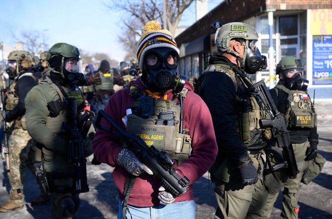 Federal agents monitor protests in Minneapolis, Minnesota, on Jan. 24, 2026, following the fatal shooting of resident Alex Pretti that morning