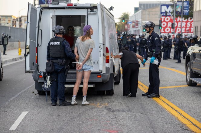 Police arrest a protester outside an immigration detention center in downtown Los Angeles on March 28, 2026