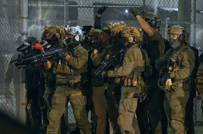 Federal agents armed with crowd-control weapons aim at protesters outside the Delaney Hall immigration detention center during a demonstration on May 29, 2026, in Newark, New Jersey.