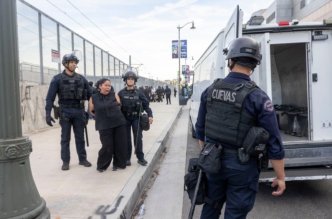 A protester is arrested outside an immigration detention center in downtown Los Angeles on March 28, 2026