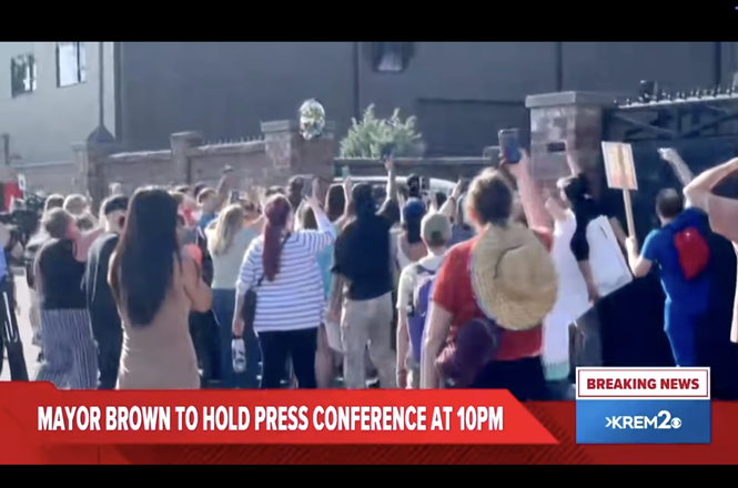 Protesters gather outside a federal Immigration and Customs Enforcement office in downtown Spokane, Washington, on June 11, 2025. A reporter for a local news outlet was shoved by ICE agents and their reporting notebook damaged while covering the protest.