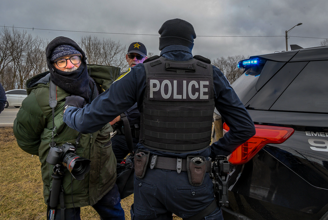 Freelance photojournalist Matthew Kaplan, at center left in green, was the first journalist known to be arrested this year, when he was detained covering an anti-deportation protest in Gary, Indiana, on Jan. 18, 2025.