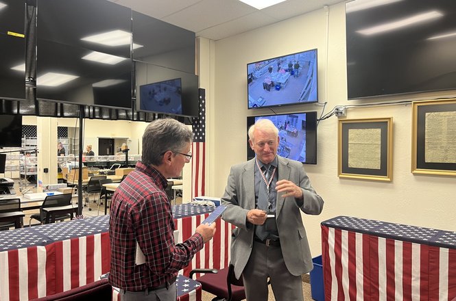The Shasta County, California, Registrar of Voters Clint Curtis, at right, responds to questions from a reporter. The official briefly excluded online outlet Shasta Scout from its media distribution list starting Oct. 3.
