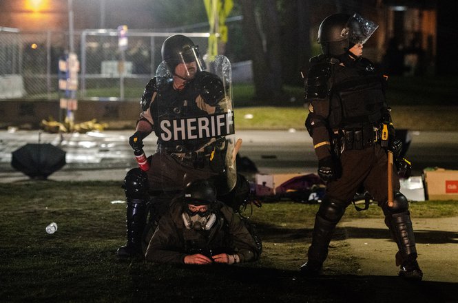 Photojournalist Chris Tuite captured the detainment of fellow photojournalist Tim Evans during an April 16 protest in Brooklyn Center, Minnesota. Evans said the officer who detained him kneeled on his back and used a shield to push down on him. (COURTESY CHRIS TUITE) Evans_arrest_0421.jpg