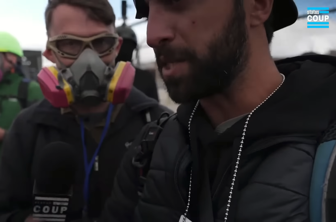 Status Coup reporter JT Cestkowski, center left, and his colleague recount being struck with pepper balls moments after both were shot at by an Illinois State Police trooper amid protests outside a federal facility in Broadview on Nov. 1, 2025.