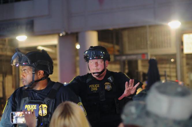 Federal officers push back people at an immigration protest in Los Angeles, California, on Aug. 9, 2026. Independent photographer Steven Berumen was shoved while documenting the demonstration.