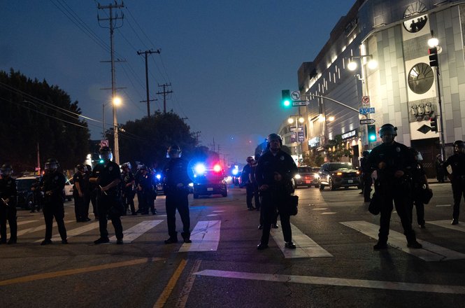 Officers line up to form a kettle during an anti-deportation protest in downtown Los Angeles, California, on June 9, 2025. Student photojournalist Jake Crandall was detained while photographing inside the kettle.