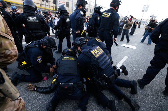 Department of Homeland Security agents restrain a protester near the Metropolitan Detention Center in downtown Los Angeles, California, on March 28, 2026