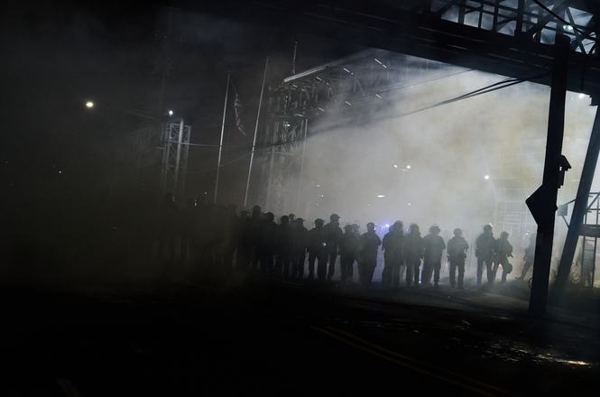 New Jersey State Police line up amid tear gas at a protest outside an immigration detention center in Newark, New Jersey, on May 30, 2026.