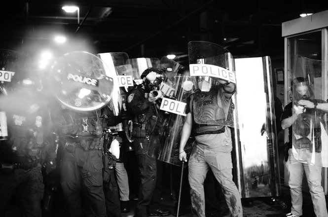 An image captures the moment a pepper ball explodes, at left, on the camera lens of photojournalist Henry Cherry during a protest in Los Angeles, California, on Jan. 30, 2026.