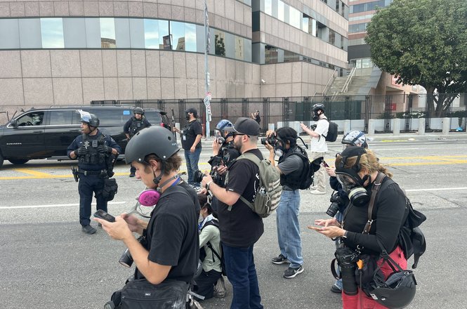 Police prevent a group of journalists from filming near where officers were making arrests at a protest in Los Angeles, California, on March 28, 2026.