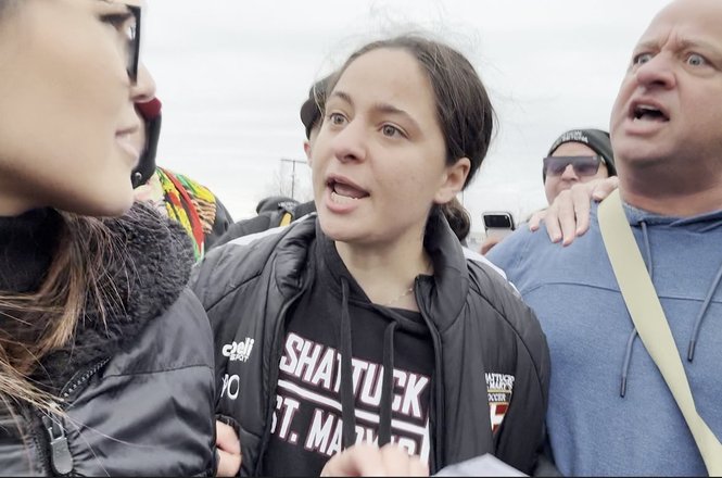Frontlines TPUSA reporter Savanah Hernandez, at left, with two individuals arrested in connection with an assault against her, seen in a video screengrab from an immigration protest in Fort Snelling, Minnesota, on April 11, 2026.
