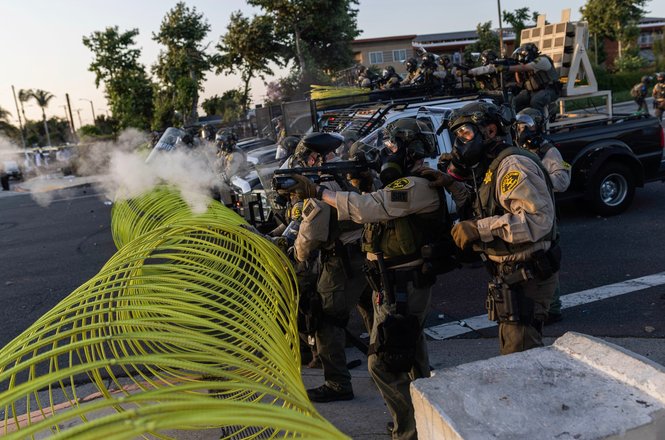 LA County sheriff’s deputies behind a mobile barrier during an anti-deportation protest in Paramount, California, on June 7, 2025. Photojournalist J.W. Hendricks was shot with a crowd-control munition after the protest was pushed into neighboring Compton.