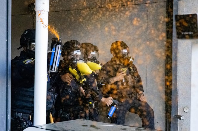 Federal officers equipped themselves with crowd-control devices during an anti-deportation protest in Los Angeles, California, on June 6, 2025. Student photojournalist Jake Crandall was pepper-sprayed by a federal officer while documenting the event.