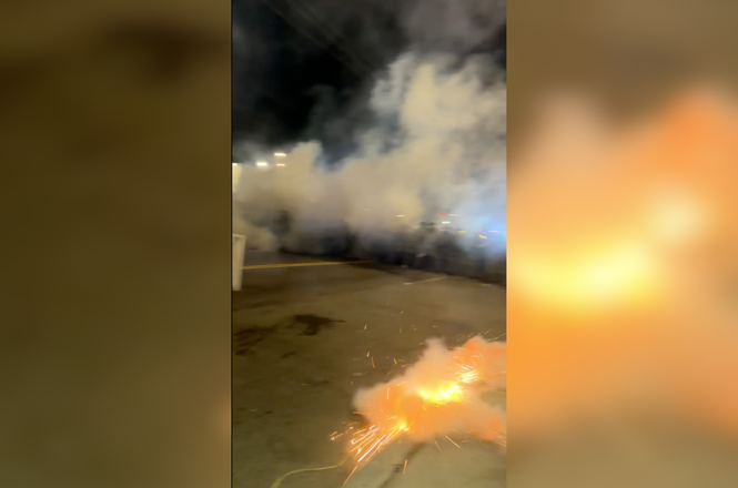 A flash-bang grenade, aimed at photographer Adriano Kalin’s feet, detonates at a protest outside the Delaney Hall immigration detention center in Newark, New Jersey, on May 30, 2026.