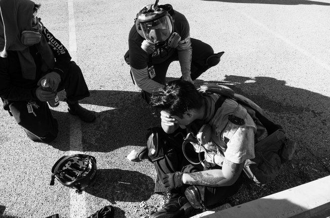 Independent journalist Wali Khan, bottom center, recovers after being shot with multiple pepper balls by federal officers while reporting on protests outside an immigration facility in Broadview, Illinois, on Sept. 26, 2025.
