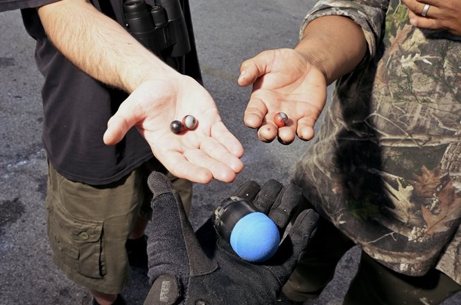 Journalist Wali Khan, at front, and others hold crowd-control munitions gathered after federal officers’ response to protests outside an immigration facility in Broadview, Illinois, on Sept. 26, 2025. Khan was struck with a pepper ball the next day.