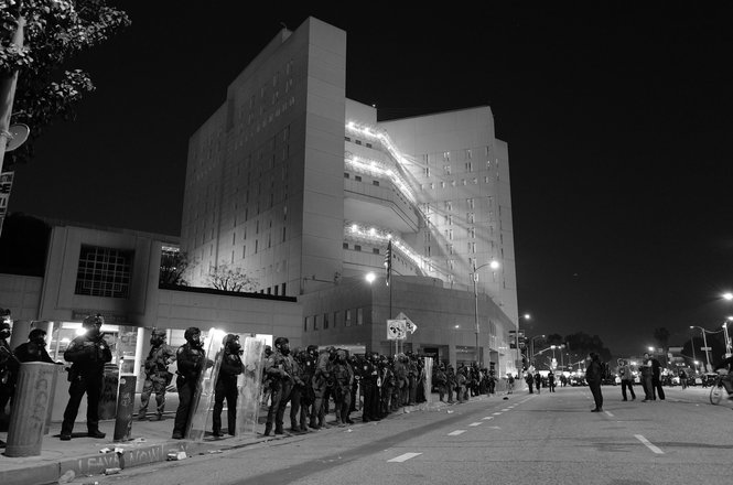 Federal officers form a skirmish line in front of the Metropolitan Detention Center in downtown Los Angeles on Jan. 31, 2026. Freelance photojournalist Moon Mandel was struck with multiple pepper balls and detained in a kettle by police that night.