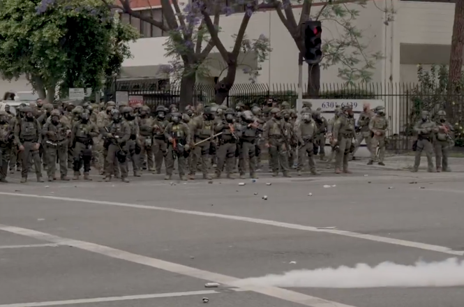A line of Border Patrol agents confront protesters near a Home Depot in Paramount, California, after an immigration raid on June 7, 2025