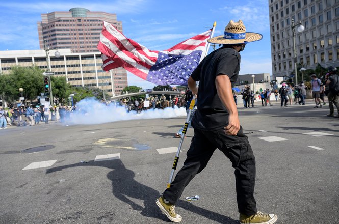 A protester holds an American flag during the “No Kings” protest in Los Angeles, California, on June 14, 2025