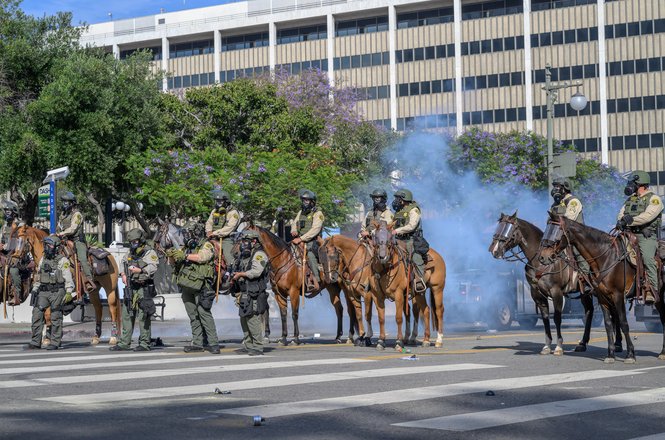 Los Angeles Sheriff’s Department personnel form a line during a “No Kings” protest in Los Angeles, California, on June 14, 2025. Freelance photojournalist Tod Seelie was pushed by deputies and struck with a projectile while covering the protest.