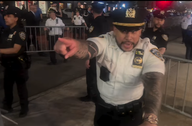 Officers use metal barricades to surround a group of press covering a pro-Palestinian protest in New York City on May 5, 2026