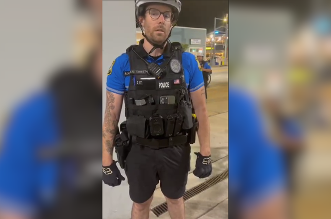 A police officer is seen in this video still asking for independent journalist Mickey Barker’s press credentials, before arresting him for violating curfew in Virginia Beach, Virginia, on April 18, 2026.