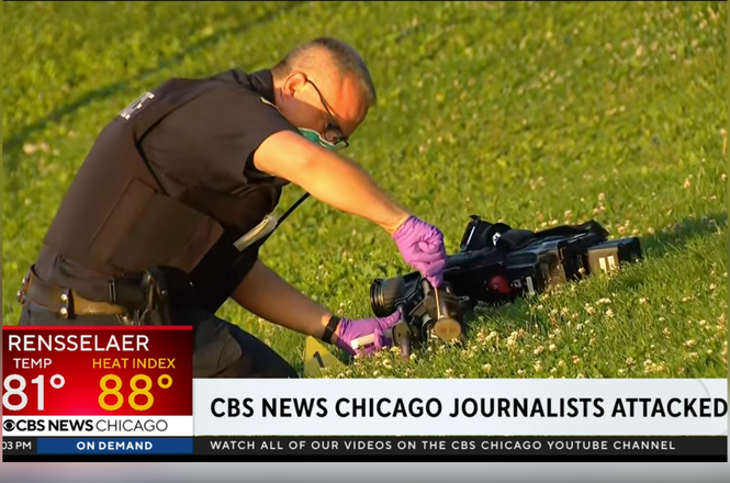 Police inspect a WBBM-TV photographer’s camera after it was damaged when a group of individuals targeted the station’s photographer and reporter on June 29, 2026, in Chicago, Illinois.