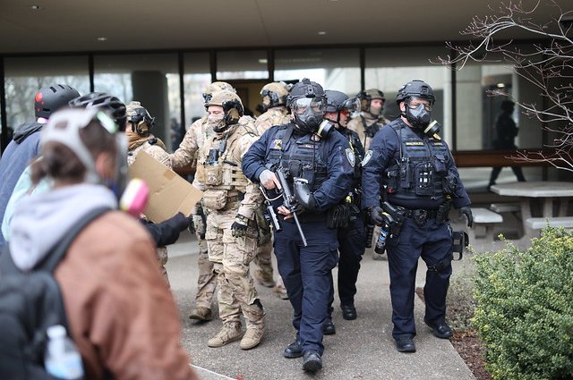 Federal agents approach protesters at the Federal Building in Eugene, Oregon, on Jan. 27, 2026