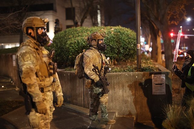 Federal officers confront protesters in front of the Federal Building in Eugene, Oregon, on Jan. 27, 2026.