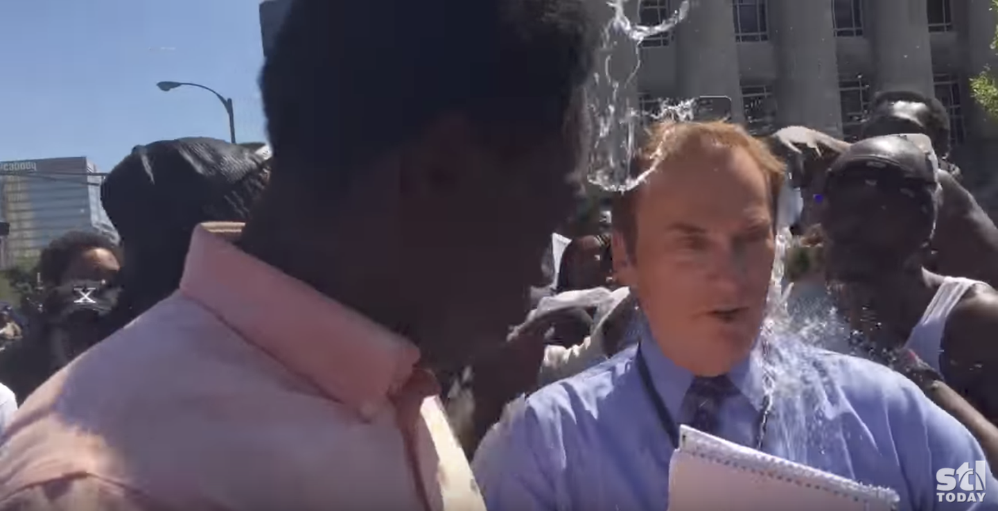 KTVI reporter Dan Gray hit with water