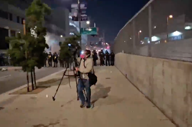 Video journalist Raúl Gutiérrez of KMEX-DT retreats as federal police deploy crowd-control munitions during an immigration protest in downtown Los Angeles, California, on June 7, 2025.