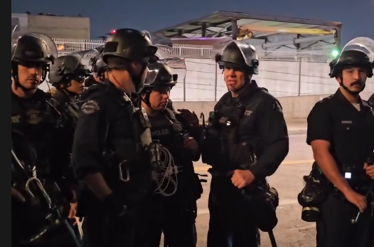Police officers who encircled protesters during an immigration protest on Jan. 31, 2026, in Los Angeles, California, also trapped journalist Dexter Thomas, who was detained and threatened with arrest.