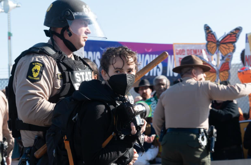 An independent journalist, at center left, is arrested while documenting a protest outside a U.S. Immigration and Customs Enforcement facility in Broadview, Illinois, on Nov. 14, 2025.