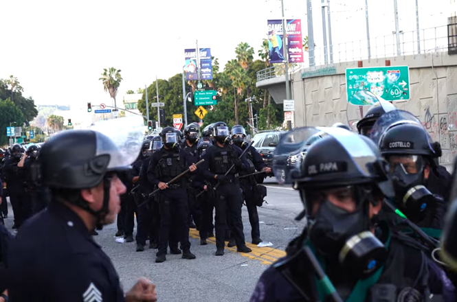 Police responding to a protest in Los Angeles, California, on March 28, 2026. Journalist Mel Buer was kettled and prevented from leaving an area while documenting the demonstration.